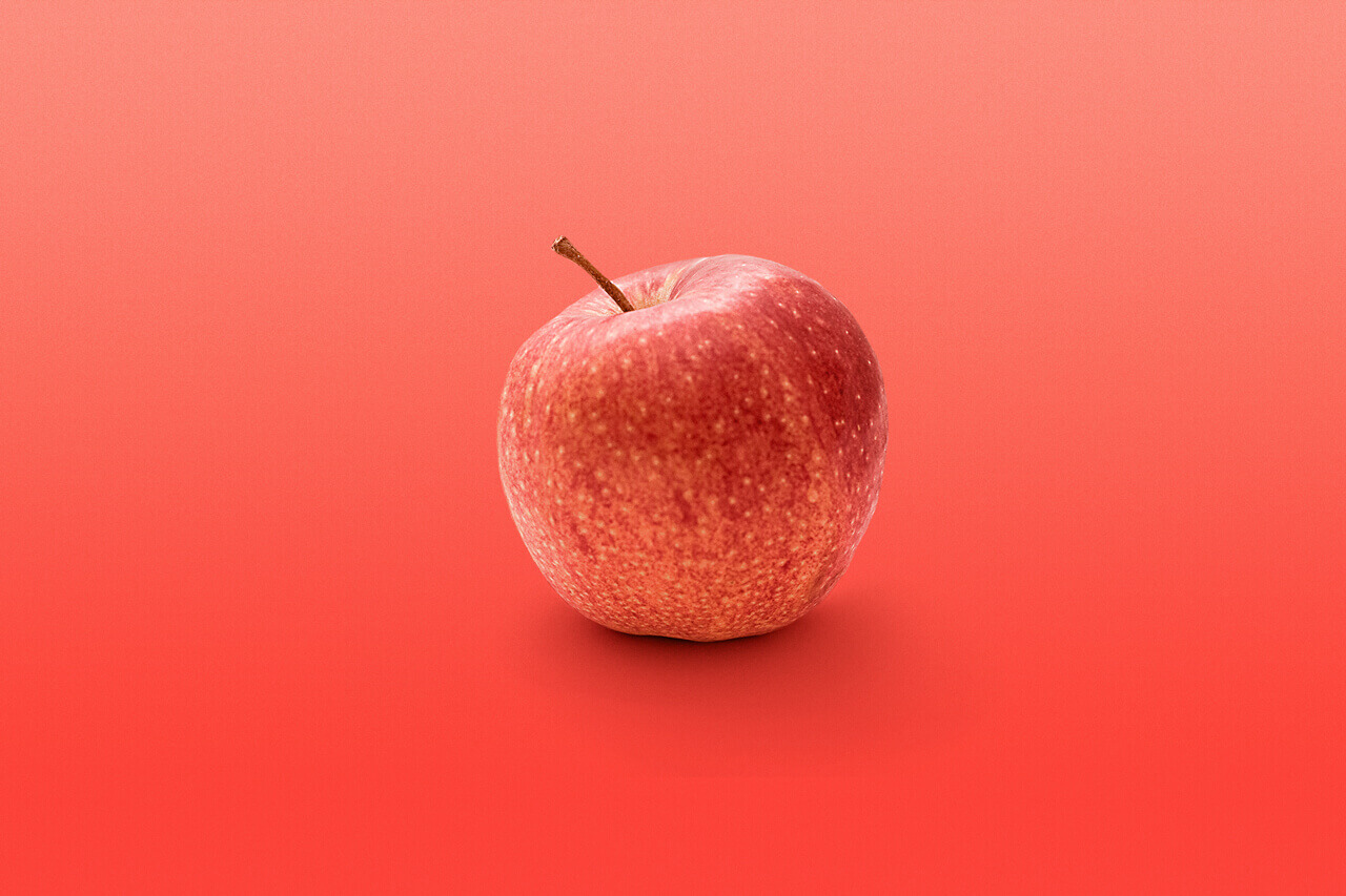 Apfelfrucht auf rotem Hintergrund
